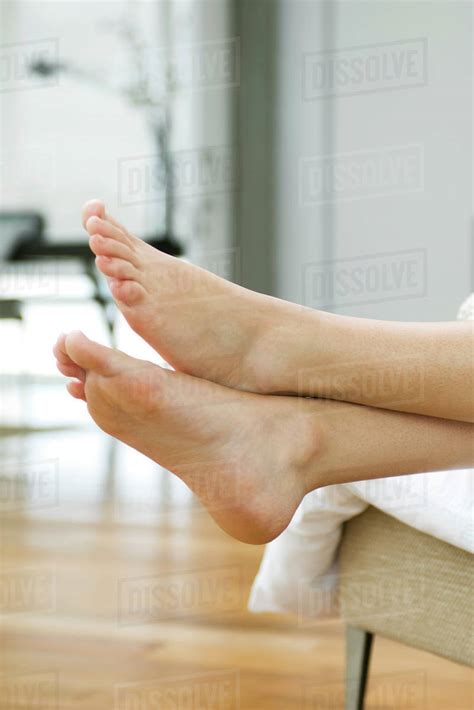 Woman S Bare Feet Legs Crossed At Ankle Stock Photo Dissolve