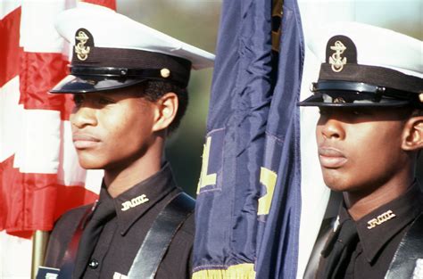 Navy Junior Rotc Color Guard Members Stand At Attention During Field