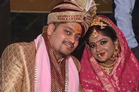 Indian Wedding Couple Posing For Photograph Beautiful Bridal Makeup Of Bride Is Visible With