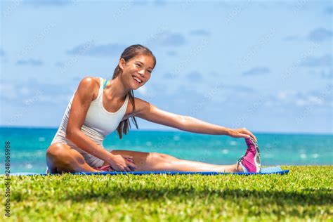 Fitness Woman Stretch Legs Doing Warm Up Before Run Workout Training Outdoor Asian Athlete