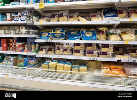 Cheese Display In Plastic Packaging In A Tesco Supermarket Uk Stock