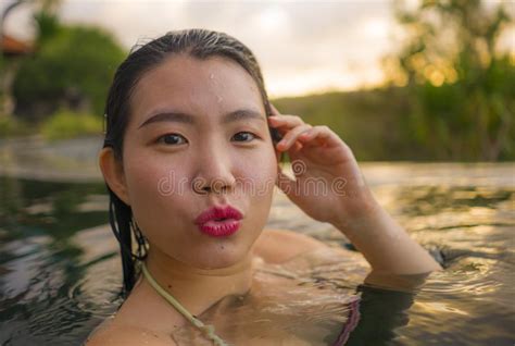 Young Beautiful And Happy Asian Chinese Woman In Bikini Enjoying Sunset