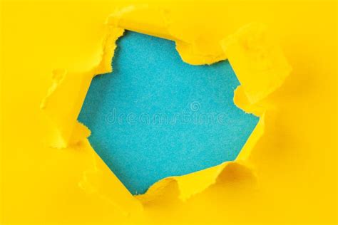 Yellow And Blue Hole In The Paper With Torn Sides Stock Image Image