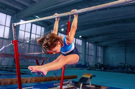 Beautiful Girl Is Engaged In Sports Gymnastics On A Parallel Bars Stock