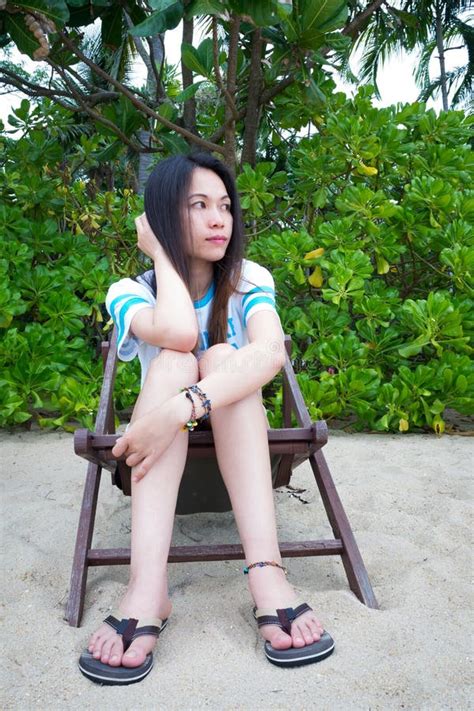 Asian Woman Relaxing On Beach Chair In Summer Vacation On Tropical