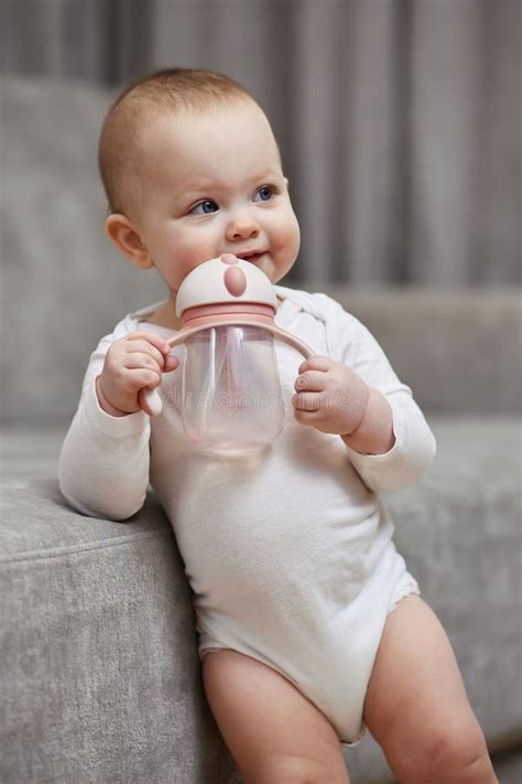 Cute Baby Girl Holding Bottle And Drinking Water Stock Image Image