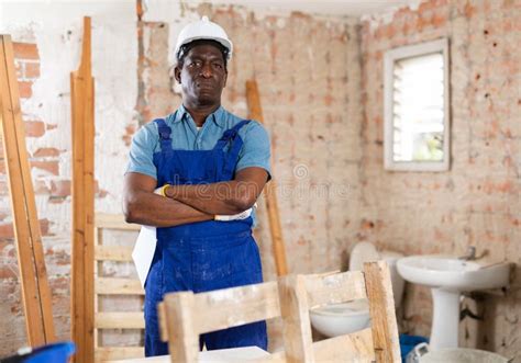 confident african american construction worker in house under renovation stock image image of