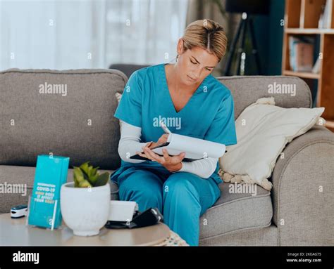 Medical Sofa And Nurse Writing Notes In Living Room At Home Care With