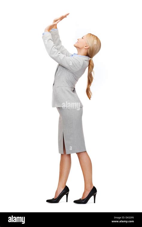 Businesswoman Pushing Up Something Imaginary Stock Photo Alamy