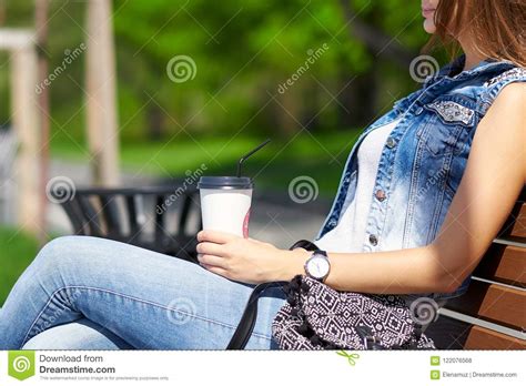 Beautiful And Young Girl Sitting On The Bench Woman