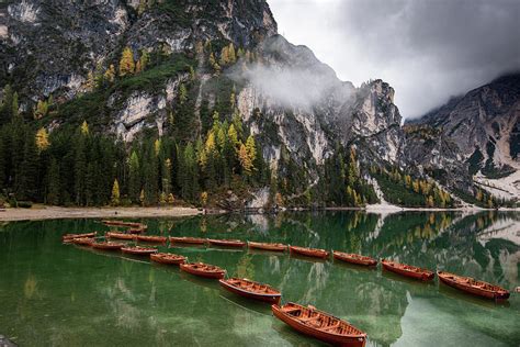 Wooden Boats On The Peaceful Lake Lago Di Braies Italy Photograph By