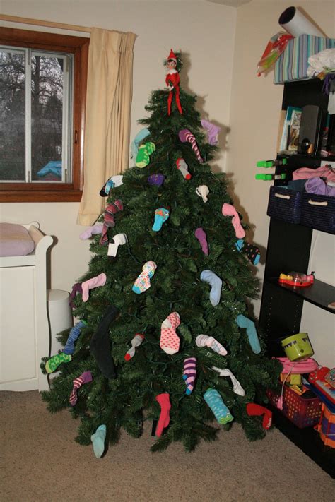 Decorating The Christmas Tree With Clean Socks From The Laundry Basket