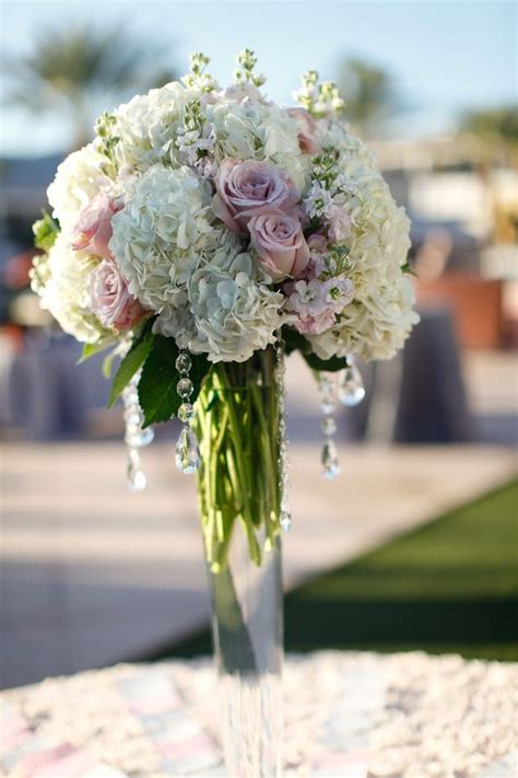 Another nice idea is the white floral corsage placed on an elegant grey clutch. Tall-White-Hydrangea-Pink-Rose-Centerpiece | Hydrangea ...