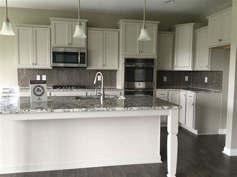 The neutral color palette of the laminate cabinets is just the beginning of what's to love in this space when you add clever design features like floating shelves, wine storage cabinets, and upper glass cabinetry. lillian cabinets | www.stkittsvilla.com