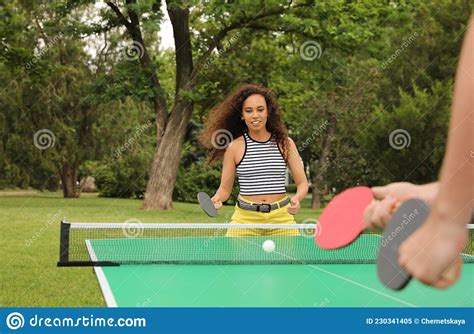 Young African American Woman Playing Ping Pong With Friend Outdoors Stock Image Image Of
