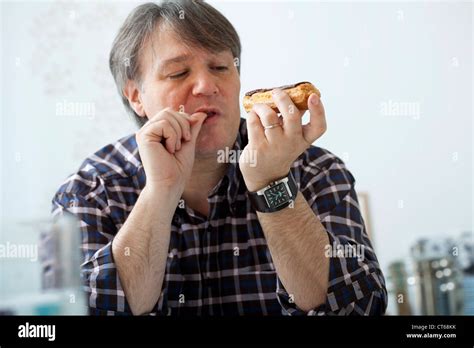 Man Eating Sweets Stock Photo Alamy