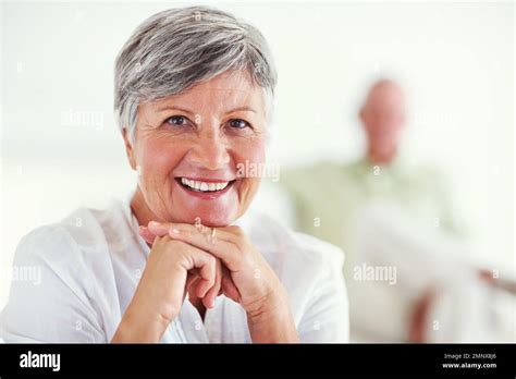 Smiling Mature Woman With Man In Background Portrait Of Mature Woman