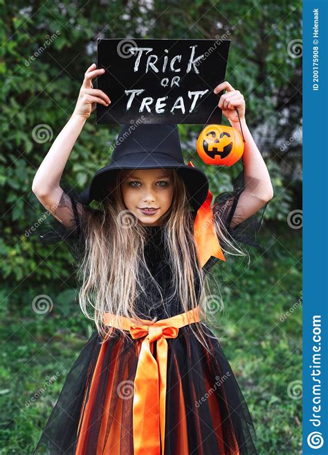 Little Girl In Witch Costume Trick Or Treating Outdoor Happy Halloween