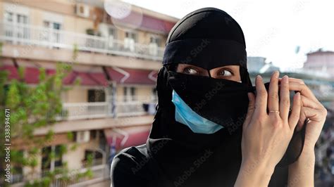 Woman With Hijab Wearing Medical Face Mask Underneath The Niqab