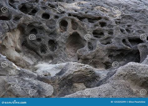 Water Worn Holes In Dark Sandstone Rock In Southern Utah Stock Image