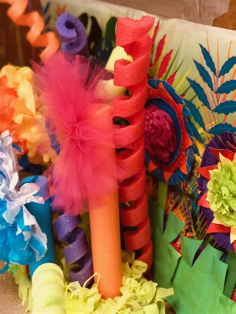 Colorful Paper Flowers And Feathers Are On Display