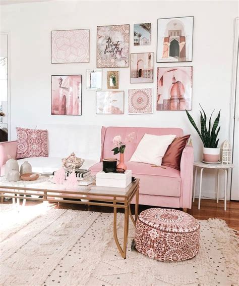 A Living Room With Pink Furniture And Pictures On The Wall