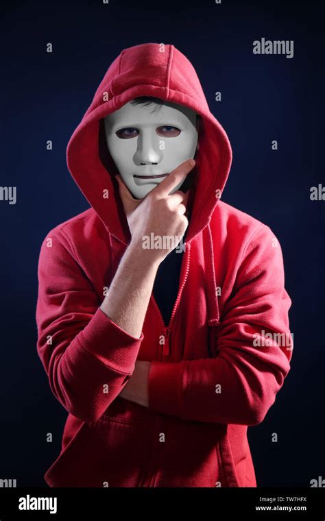 Masked Hacker Wearing Hoodie In Darkness Stock Photo Alamy