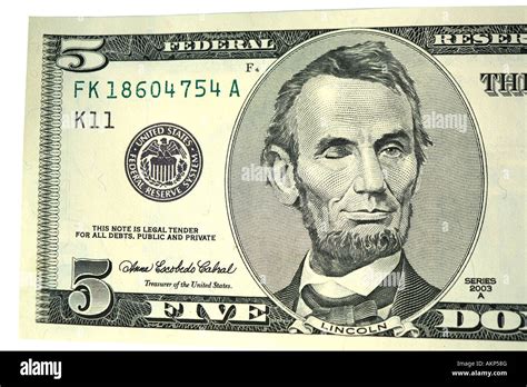 Abraham Lincoln Winking On Five Dollar Bill Isolated On White Stock