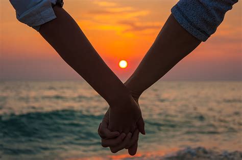 Couple Holding Hands On Beach