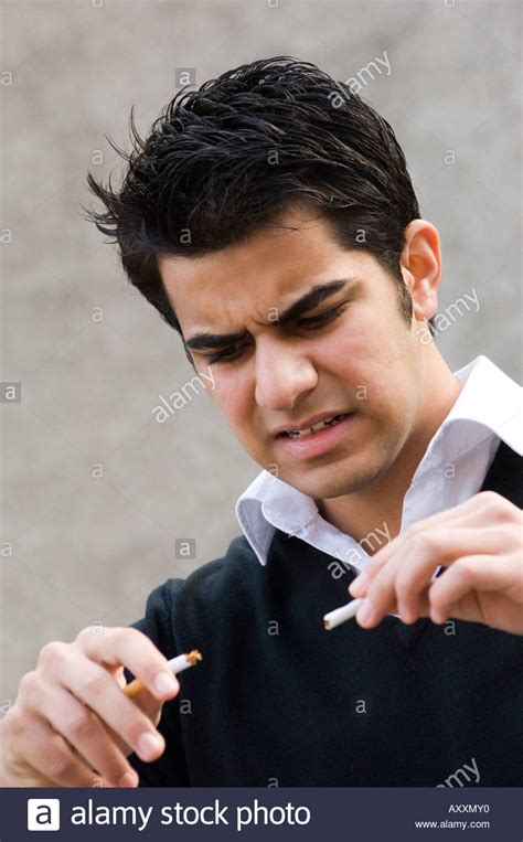 Young Man Breaking A Cigarette Stock Photo Alamy