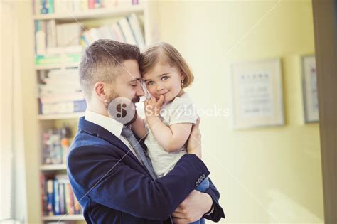 Young Father Hugging His Daughter As He Gets Home From Work Royalty Free Stock Image Storyblocks