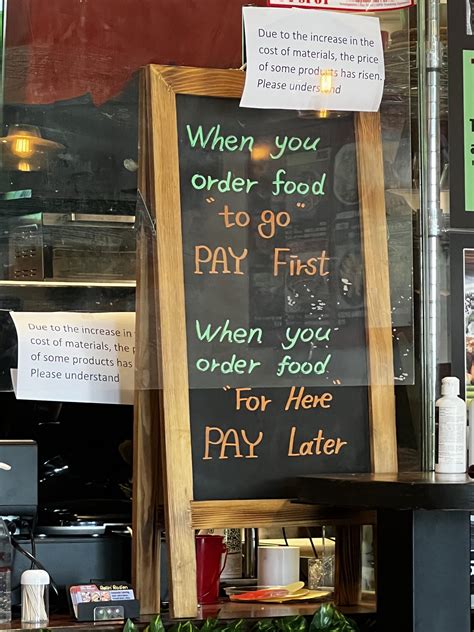 Sign At A Restaurant Clearly Stating How To Pay For Different Types Of