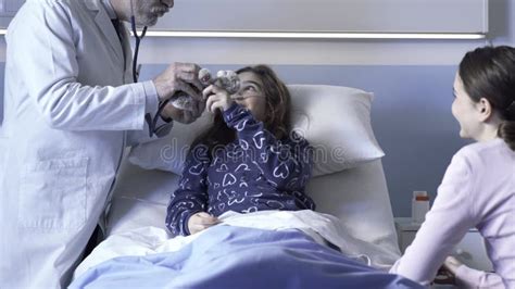 Friendly Doctor Assisting A Patient And Playing With Her Stock Video