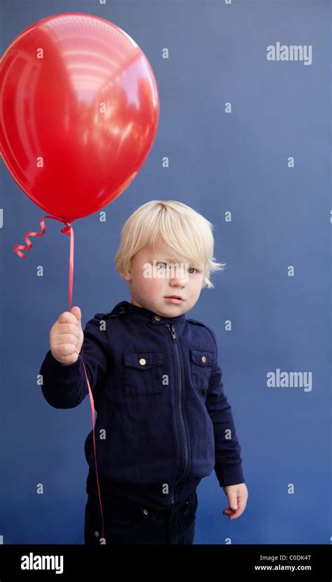 Little Boy Holding Red Balloon Stock Photo Alamy