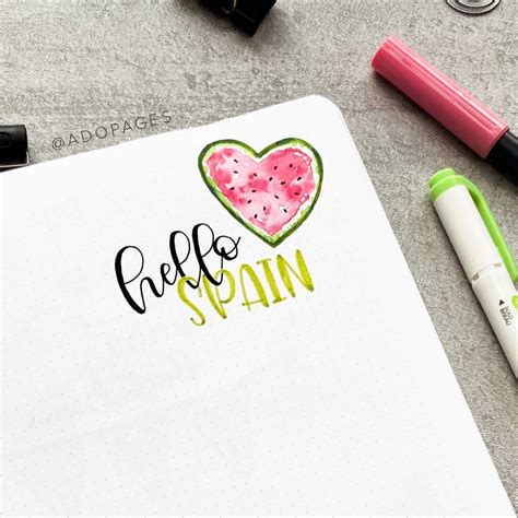 An Open Notebook With The Word Hello Spain Written In Cursive Writing On It