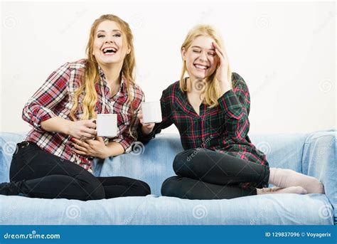 Female Friends Sitting On Sofa Having Fun Stock Photo Image Of Female