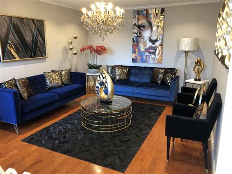 Adding accent pillows of blue and yellow added a sunny feeling to this space. Living Room | Blue Black Brown Gold Decor | Hint of Coral | Brown living room decor, Gold living ...