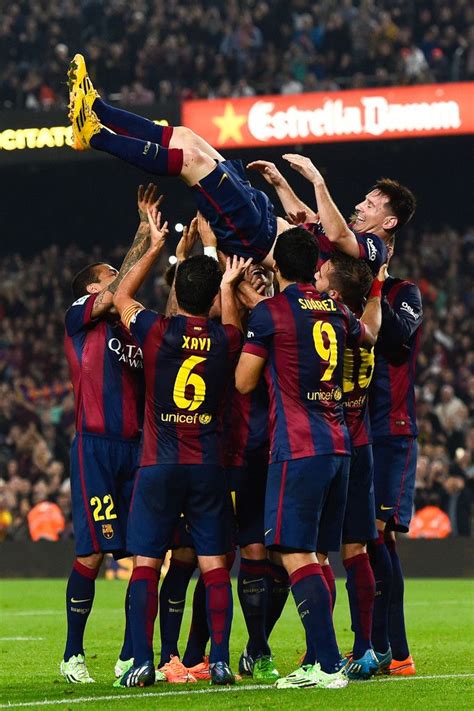 lionel messi of fc barcelona celebrates with his teammates after