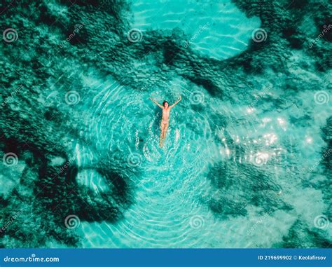 Naked Woman Floating And Relax In Turquoise Ocean Aerial View Stock