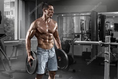 Muscular Man Working Out In Gym With Barbell Shaped Abdominal Strong