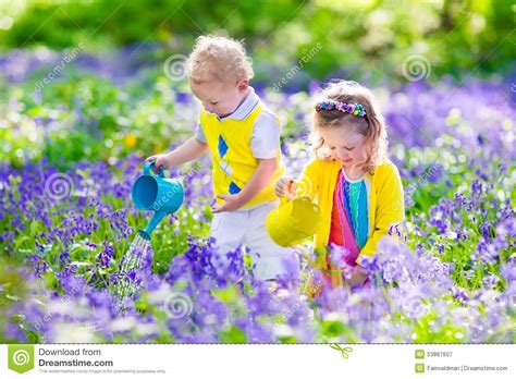 Kids In A Garden With Bluebell Flowers Stock Image Image