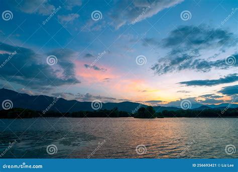 Dramatic Panorama Evening Sky And Clouds Over Mountain And Lake At