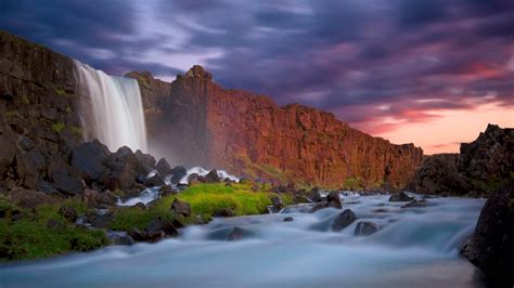 Waterfall Wall Of Red Cliffs Dark Clouds Hd Wallpaper