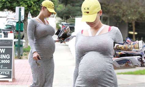 Amber Rose Displays Her Huge Belly In A Tight Lycra Dress As She