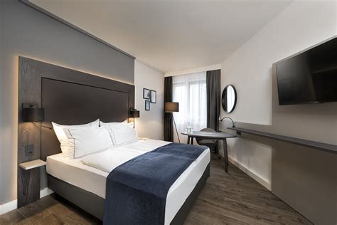 Bathrooms include shower/tub combinations, slippers, and hair dryers. 4-star Hotel Rooms in Berlin | Holiday Inn Berlin City-West