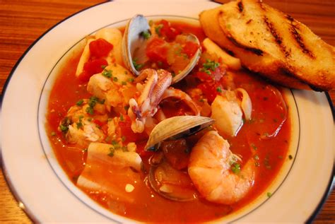 Transfer all of the cooked seafood, along with the leftover shellfish steaming liquid and reserved matignon, to the simmering stew; EAT Everyday: Cioppino with Clams, Cod, Shrimp and Squid