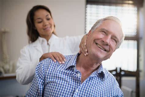 Shirtless Man Receiving Neck Massage From Therapist In Hospital Stock Image Image Of Health