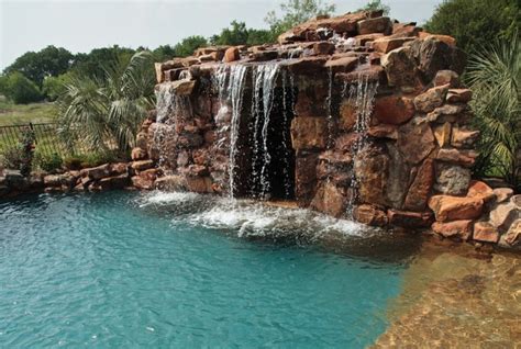 Lagoon Style Swimming Pool With Waterfall Grotto With Spa Inside