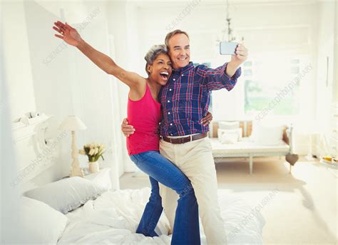 Mature Couple Taking Selfie Standing On Bed Stock Image F0167530 Science Photo Library