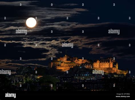 A Full Moon Supermoon Rising Above The Capital Citys Lit Up Landmark
